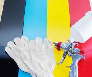brightly coloured strips with gloves and spray gun