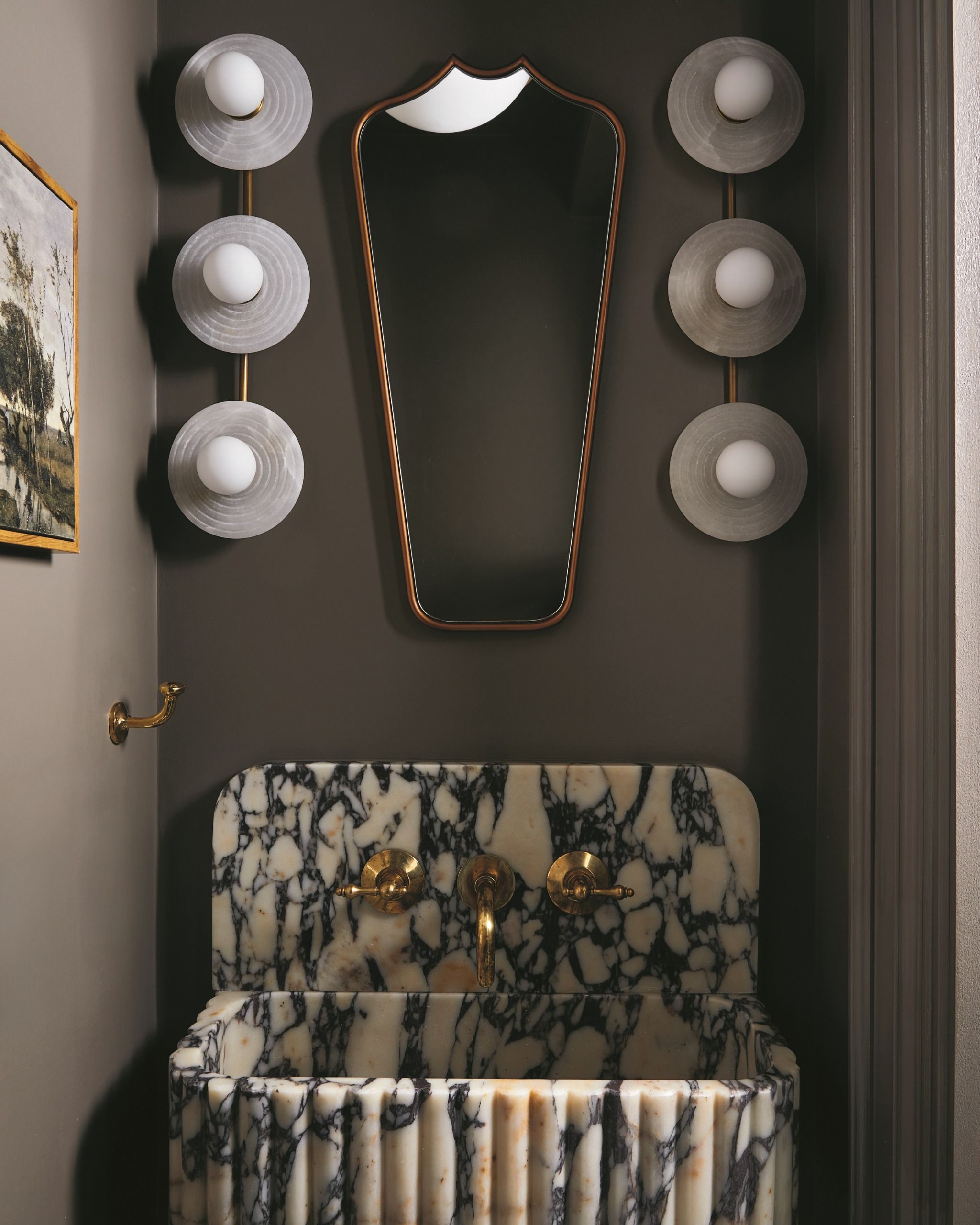 a dark grey bathroom with a viola marble sink