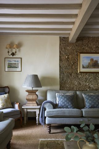 living room with exposed cob wall in17th century thatched cottage