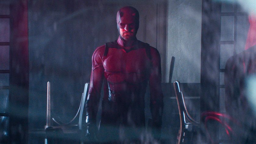 Daredevil as seen through a window with a red light shining on him in Daredevil: Born Again episode 9