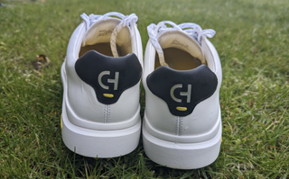 Cole Haan GrandPro AM shoes from behind on grass