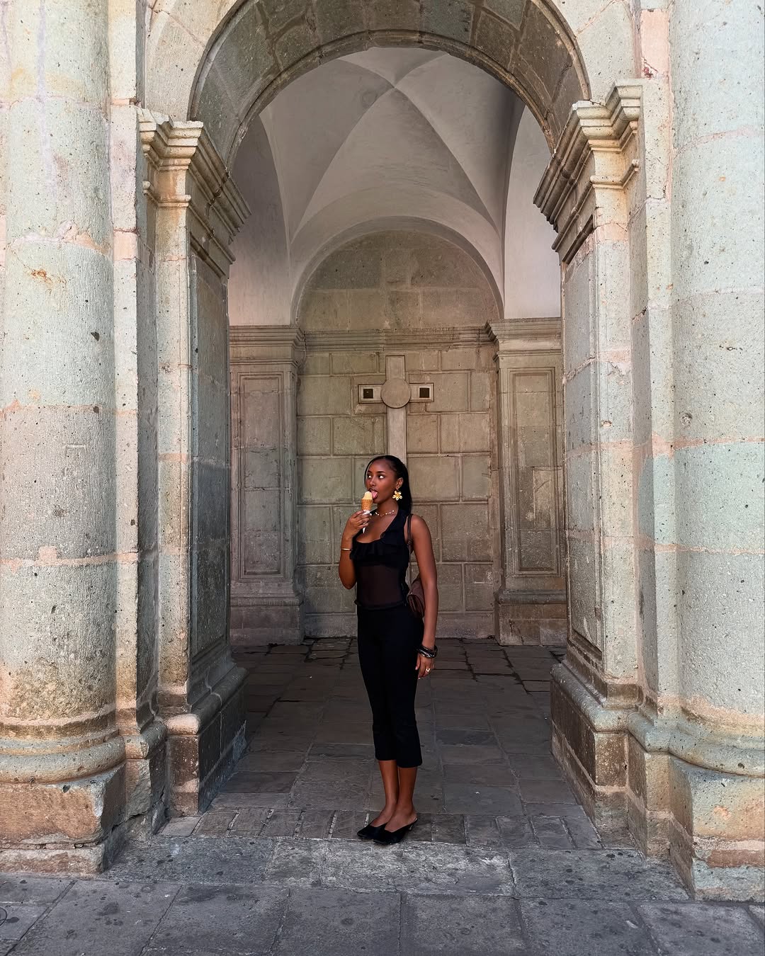 woman wearing black midi dress and black flats