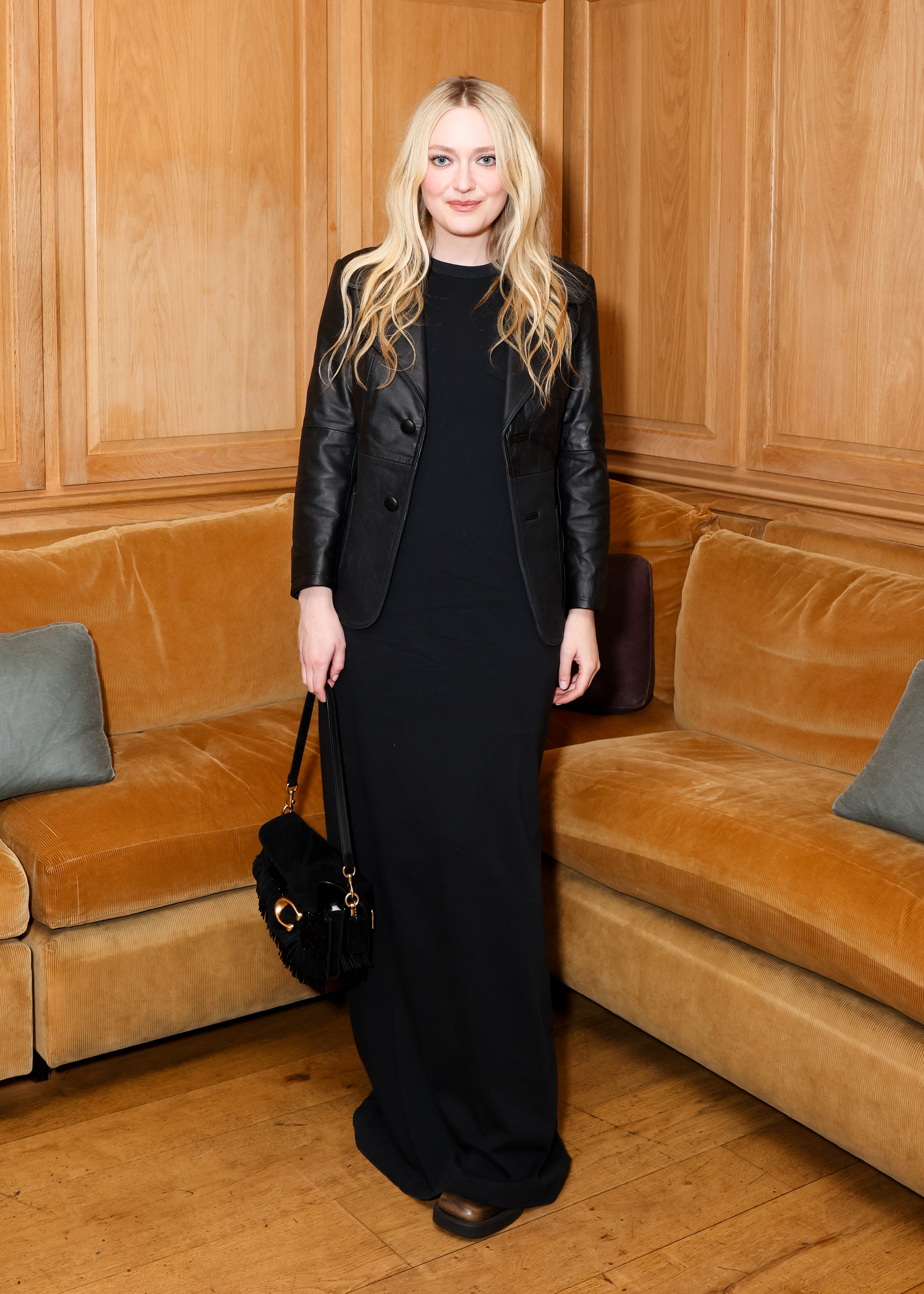 Dakota Fanning wears a black leather jacket at a Coach dinner in Los Angeles