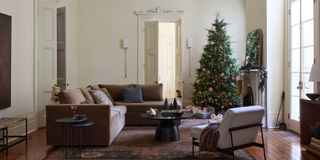 A chic living room with a Christmas Tree in the corner