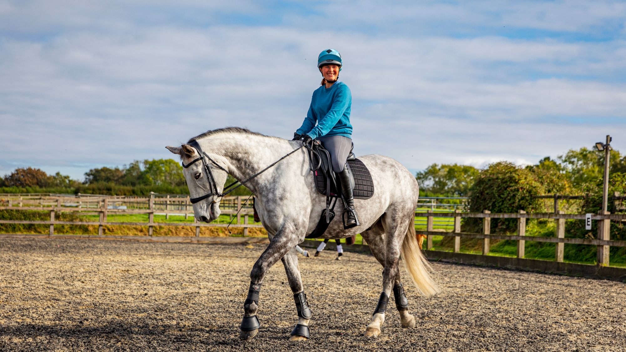 Rider practising walk on a circle with a slight inside bend to encourage suppleness and stretch into the contact