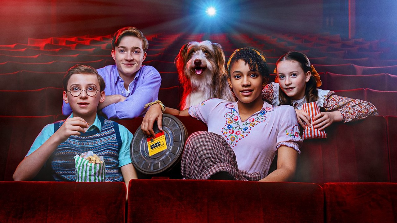 From left to right: Dick, Julian, Timmy, George and Anne - aka The Famous Five - sit in a cinema bathed in the glow of a movie projector, in a promo image for The Famous Five: Big Trouble on Billycock Hill&quot;.