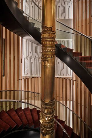 A close-up picture of the grand spiral staircase based on a design at Portman’s home in Atlanta