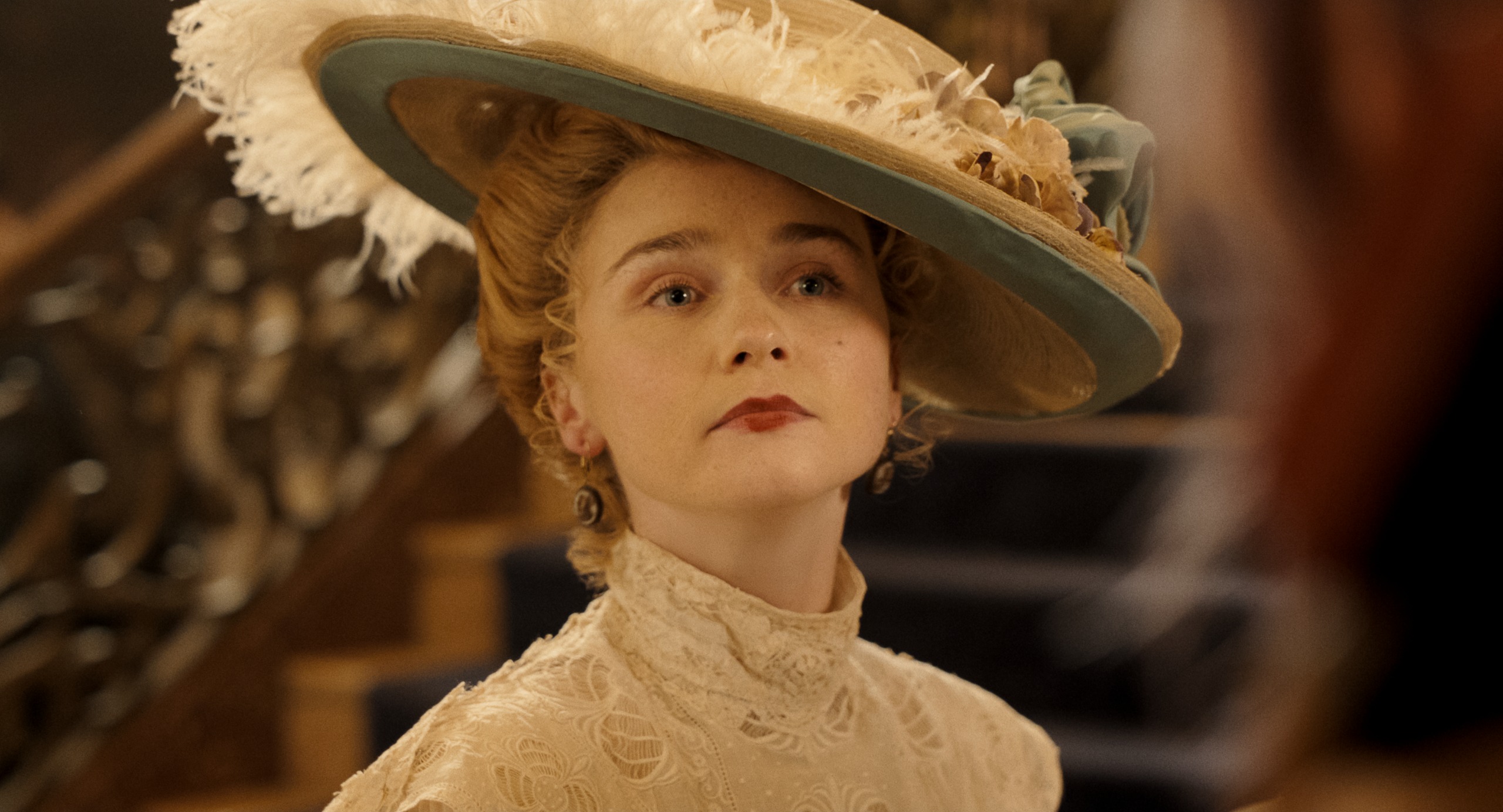 Actress Jessica Barden wears a large tilted hat and a high-neck dress in a still image from Netflix's 'Monster: The Lizzie Borden Story.'