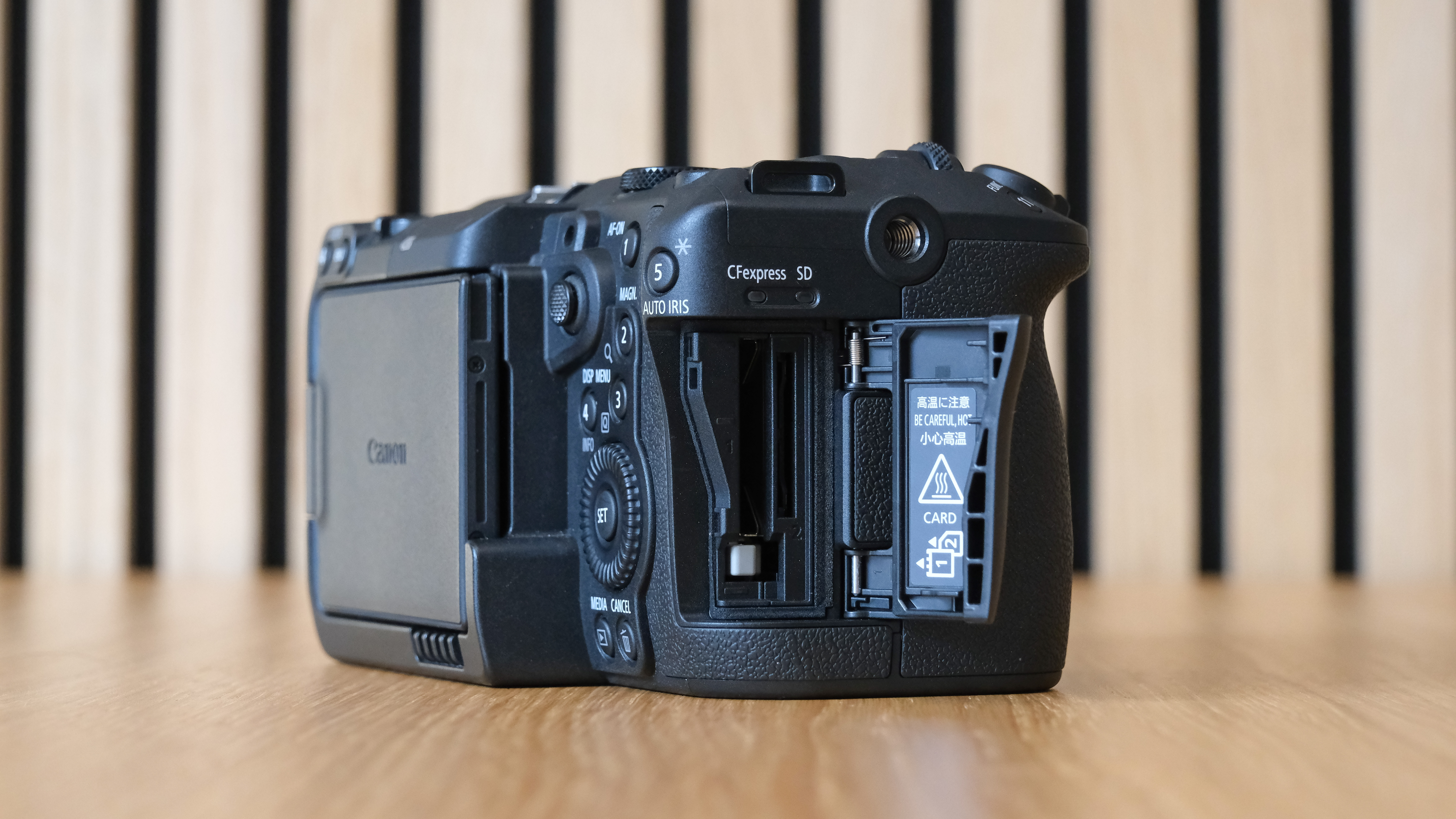 Canon EOS C50 against a striped wooden background