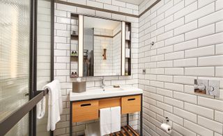 bathroom with white subway tile and glass sliding doors to shower