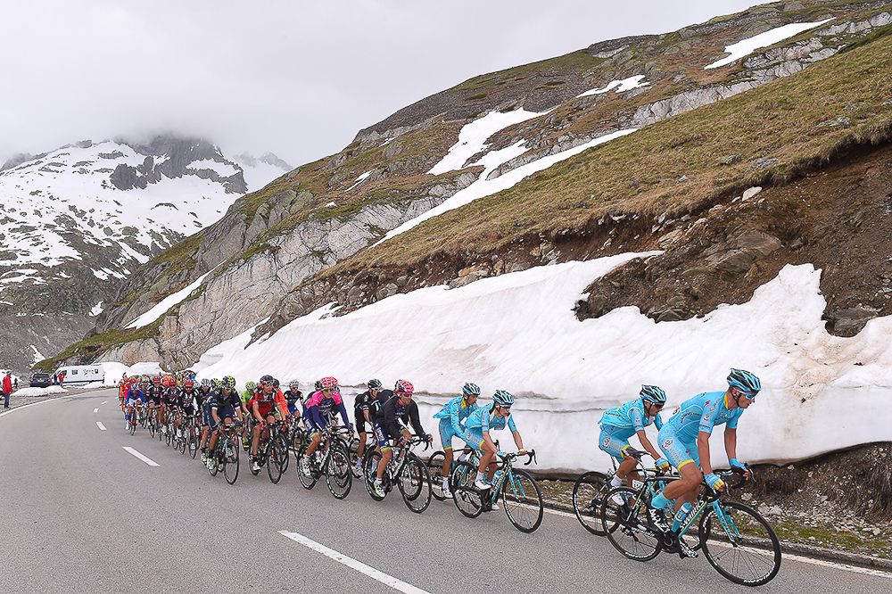 The peloton climbs into the snow line climbs during stage 5 at Tour de Suisse