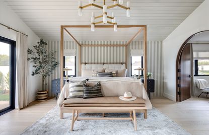 A bedroom with a bench by the bed