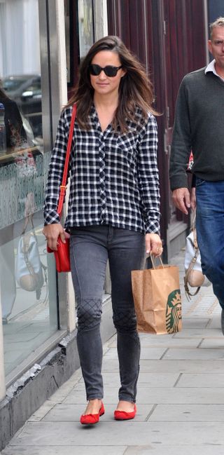 Pippa Middleton walking down the road carrying a brown paper Starbucks bag