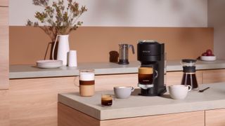 A Nespresso coffee machine sitting on a countertop in a modern kitchen