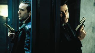 Nicolas Cage and John Travolta holding guns in Face/Off