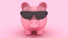 A piggy bank wears dark sunglasses.