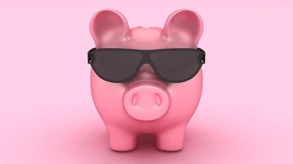 A piggy bank wears dark sunglasses.
