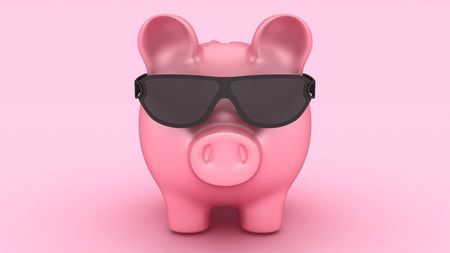 A piggy bank wears dark sunglasses.