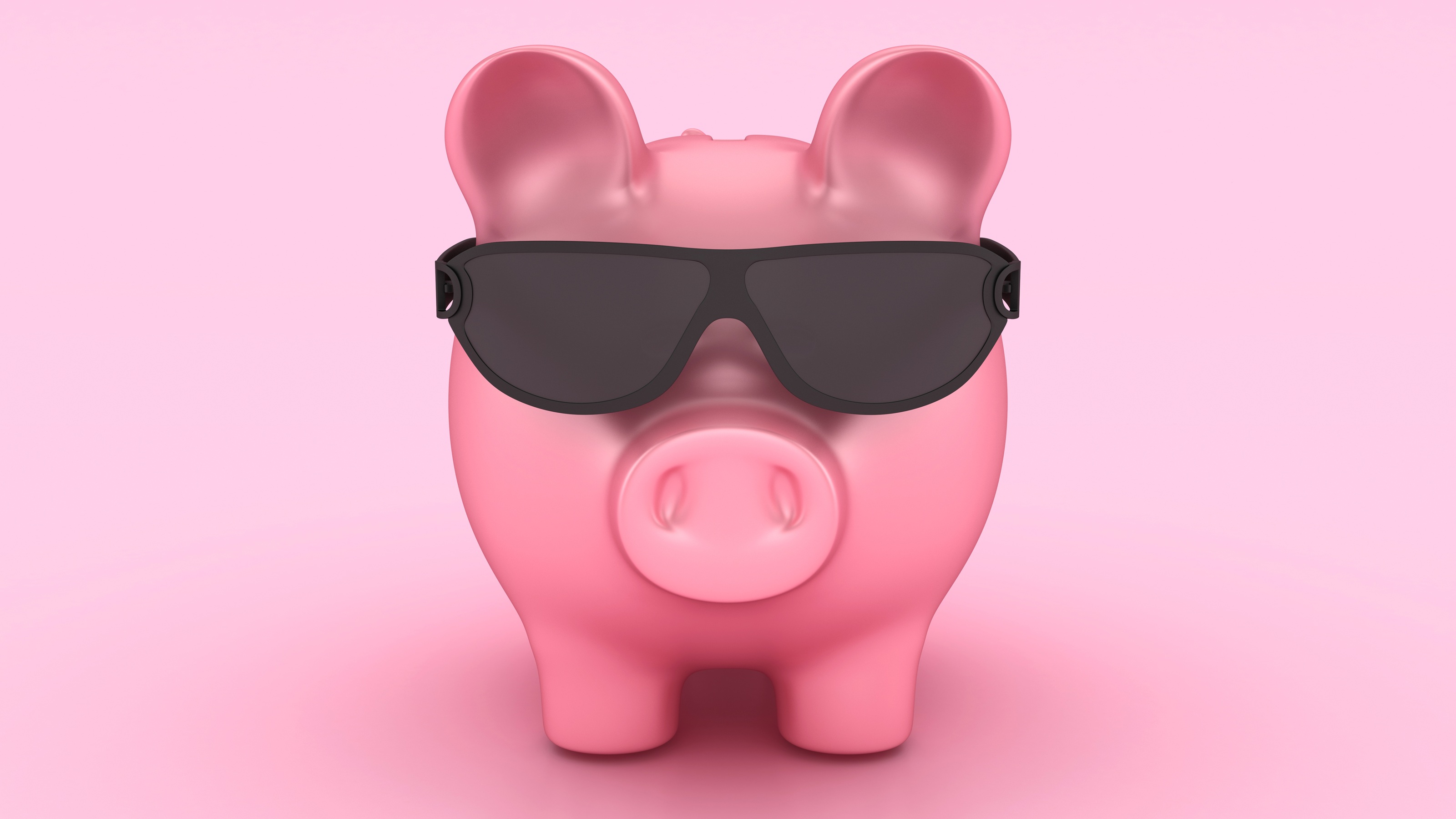 A piggy bank wears dark sunglasses.