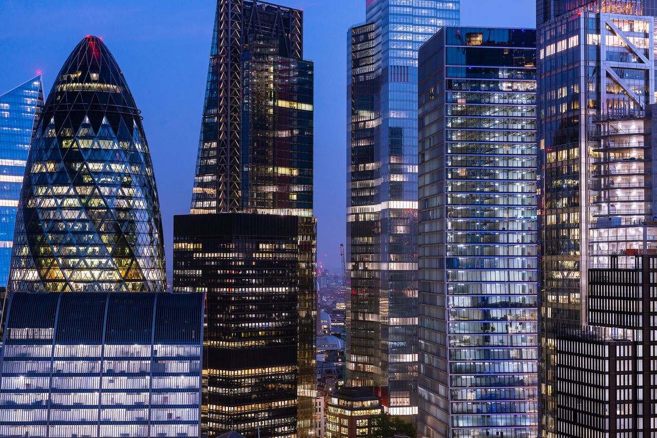 Elevated view of London&#039;s financial district at night.