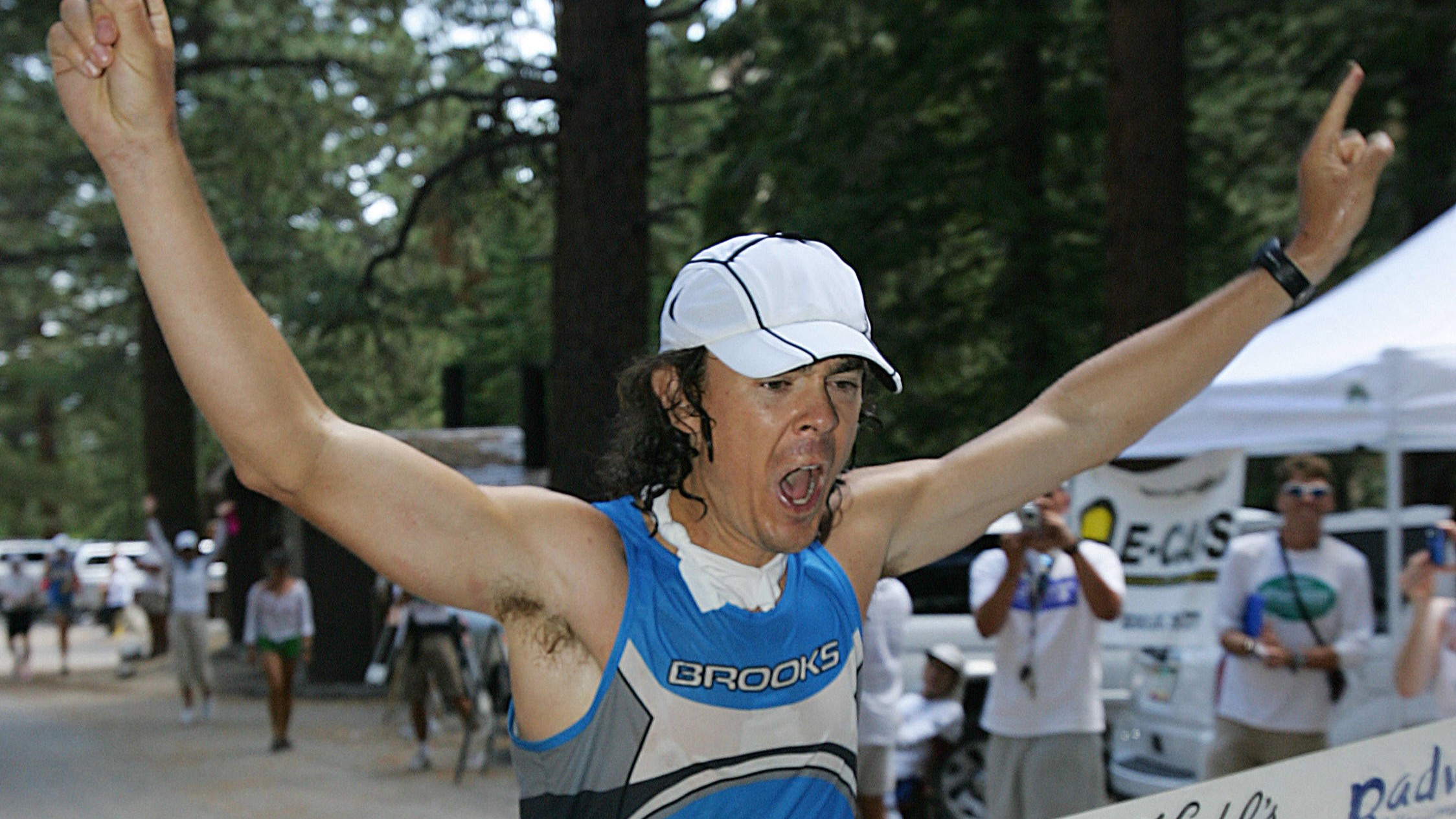 Defending champion Scott Jurek, 32, of the US crosses the finish line at Whitney Portal in Lone Pine, California, to win the Kiehl Badwater Ultramarathon 25 July, 2006