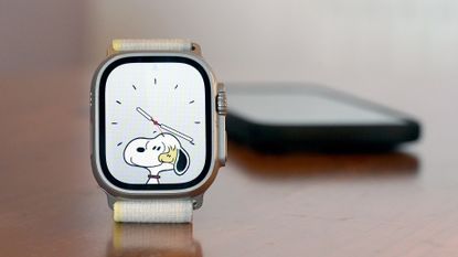Apple Watch Ultra displaying the Snoopy watch face