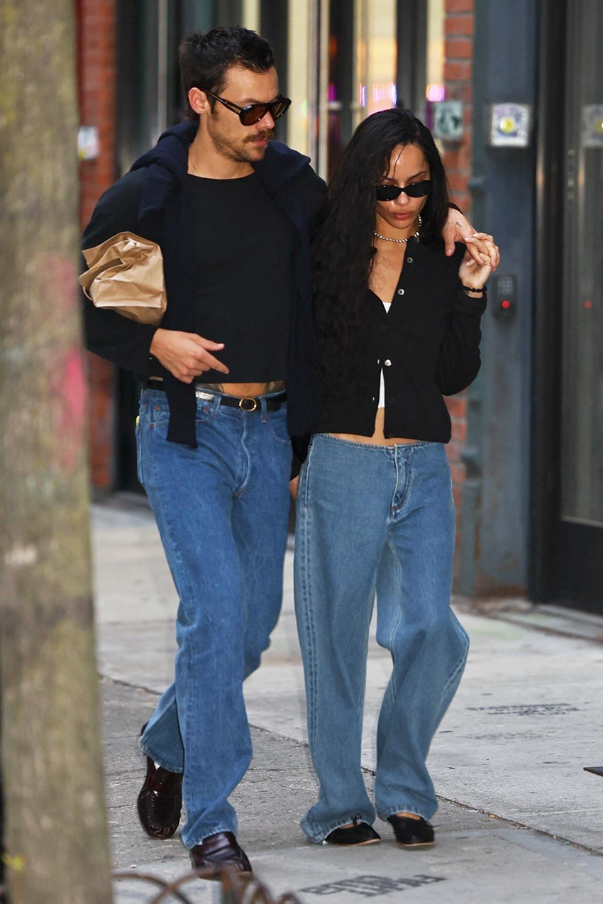 Zoe Kravitz and Harry Styles wearing black tops, jeans, and flat black shoes while walking in NYC.