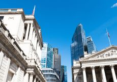 The City of London, home of the FTSE 100, skyline against a clear blue sky