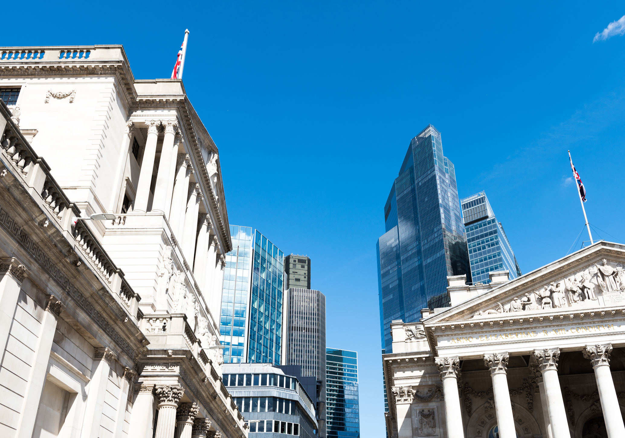 The City of London, home of the FTSE 100, skyline against a clear blue sky