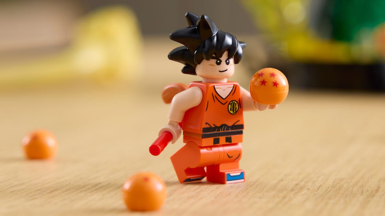 Lego Goku holding the Dragon Balls on a table