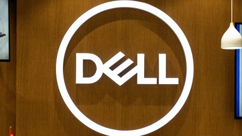 The Dell logo in white against a wood-panelled wall