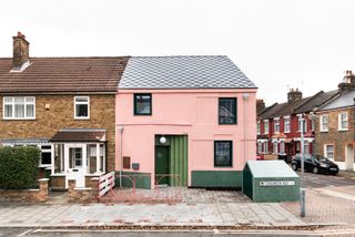 Salmen House in East London - a pink house on an ordinary British street with textured terrazzo on the door frame