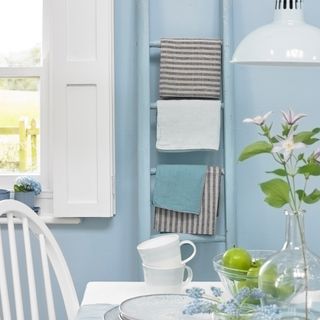Blue room with painted ladder with blankets
