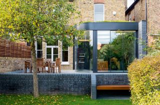 terraced house with curved glass extension added to the back photographed by william eckersley