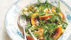 Nectarine, rocket and blue cheese salad in a blue and white bowl