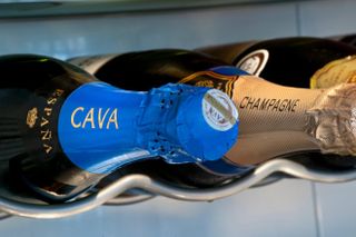 Cava and Champagne sparkling wine bottles stored horizontally in temperature controlled wine cabinet