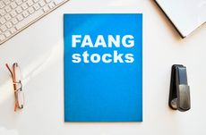 FAANG stocks written in white on blue notebook