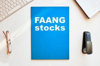 FAANG stocks written in white on blue notebook
