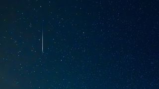 A meteor streaks across the sky during the Perseid meteor shower.