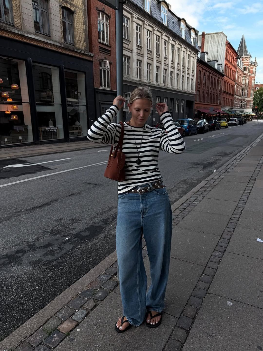 Influencer Hollie wears a Breton style top and baggy jeans.