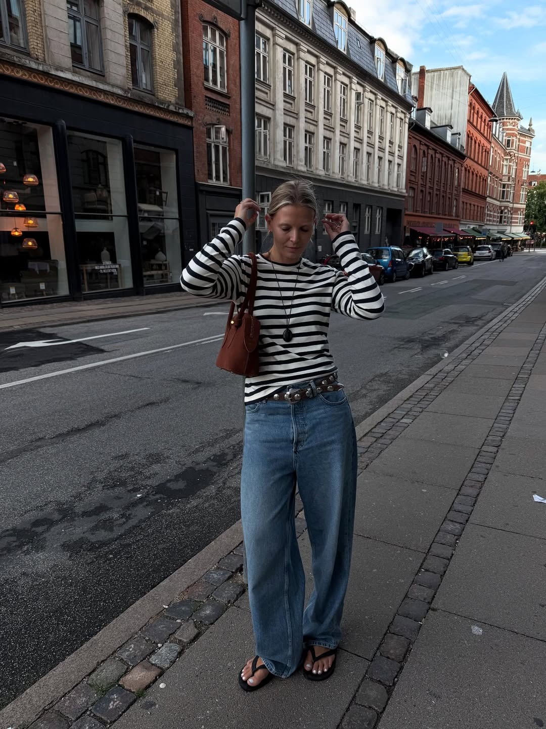Influencer Hollie wears a Breton style top and baggy jeans.