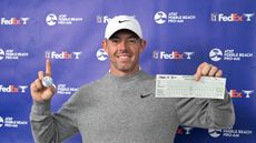 Rory McIlroy holds up his signed golf ball and scorecard after making an ace at the 2025 Pebble Beach Pro-Am (round one - Spyglass Hill)