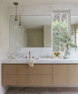 modern bathroom with floating wood vanity and plaster walls by A Naber Design
