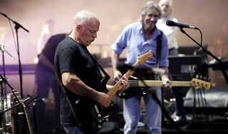 David Gilmour (left, foreground) and Roger Waters (right, background) perform with Pink Floyd at the Live 8 Festival in Hyde Park on July 2, 2005 in London