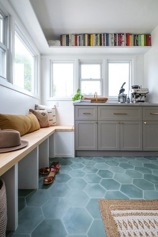 Mud room with hexagonal floor tiles, sink unit and bench seating