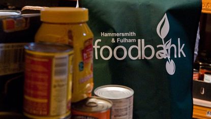 A volunteer sorts through donations at a Food Bank in London