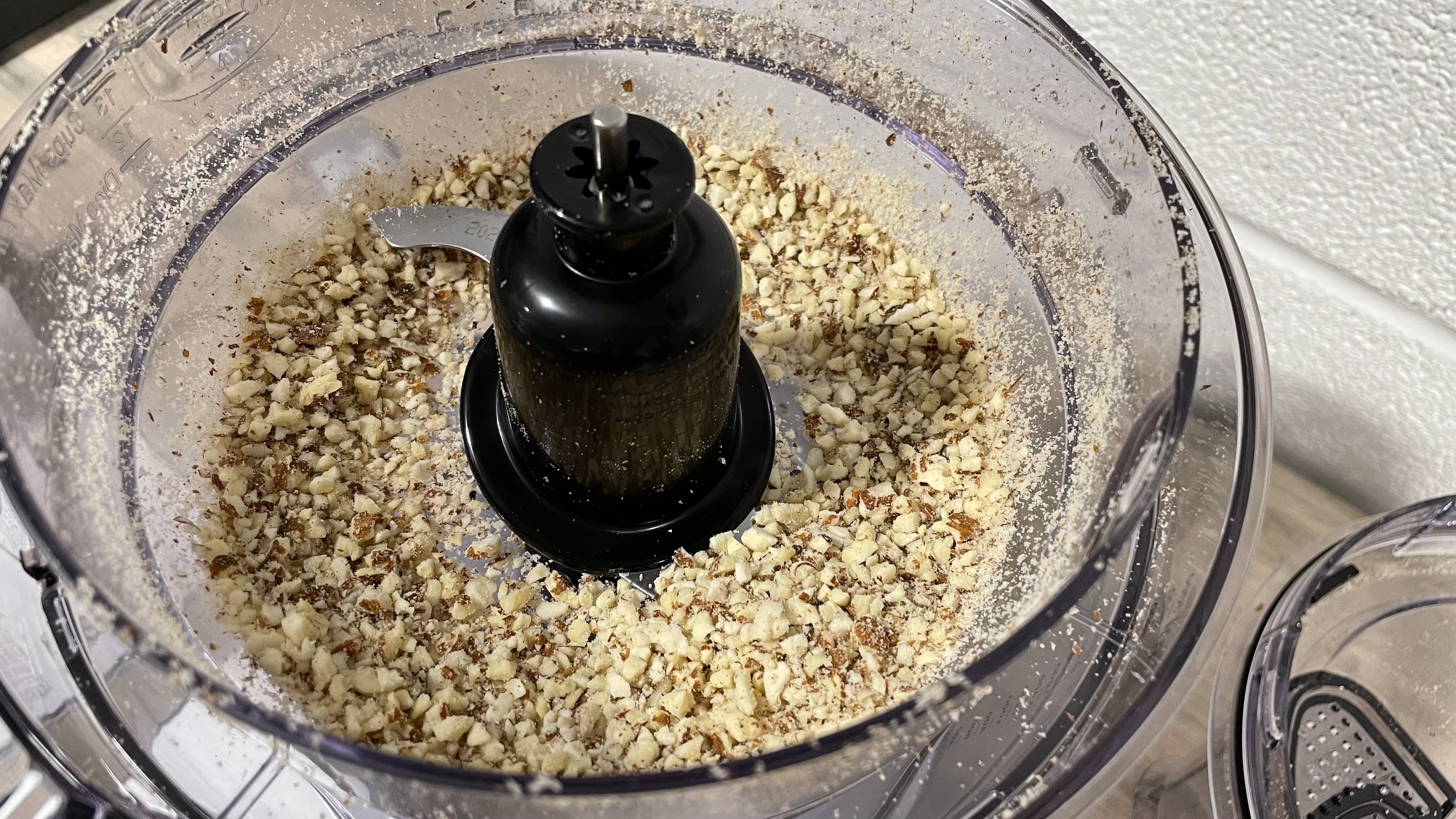 A close up of unevenly chopped lamonds inside the small work bowl of the Cuisinart Expert Prep Pro.