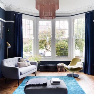 Blue living room with grey sofa blue rug