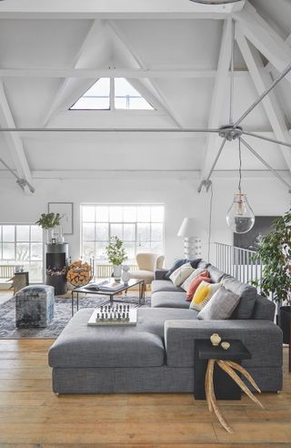 white living room with grey sectional L-shaped sofa