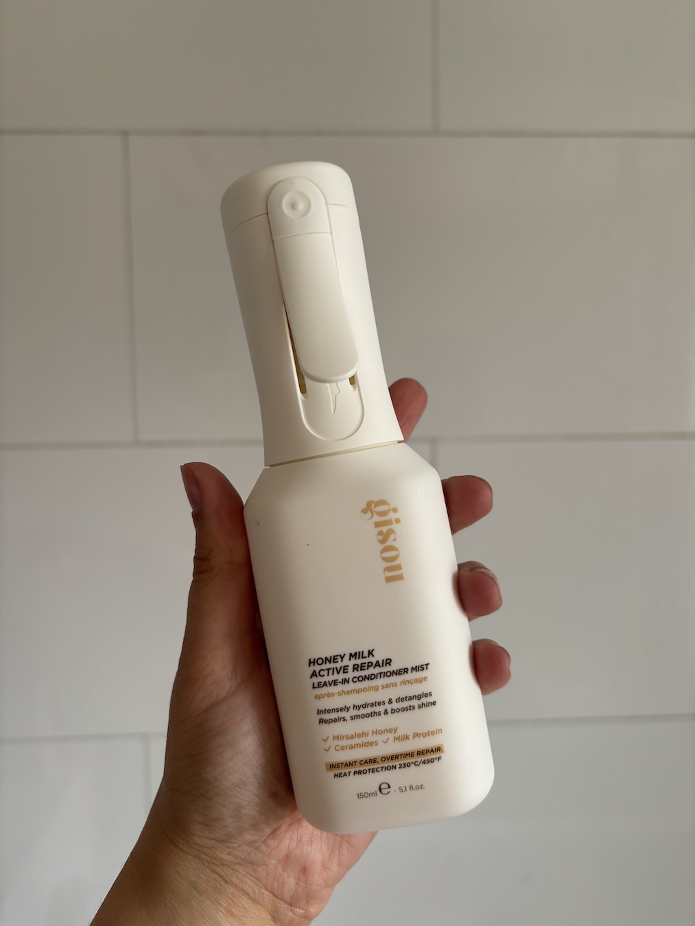 Mica Ricketts holding Gisou Honey Milk Active Repair Leave-In Conditioner